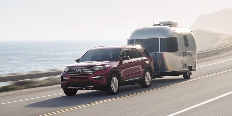 2024 Ford Explorer driving on road towing camper