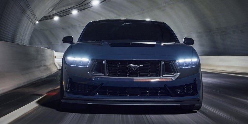 2024 Ford mustang driving through tunnel with headlights on