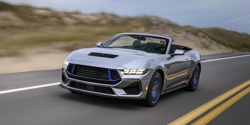 silver 2024 Ford mustang driving with roof off