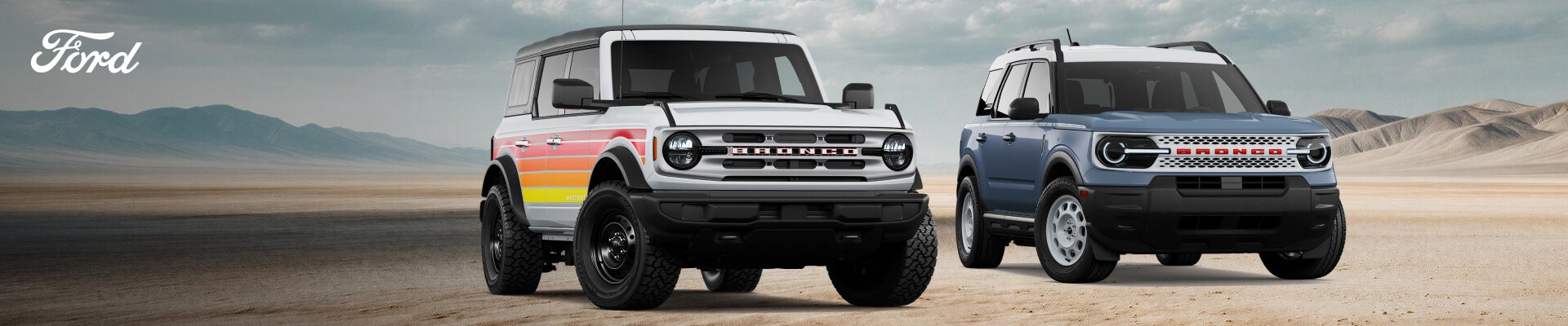 2026 Ford Bronco Big Bend in Oxford White and Bronco Sport Heritage in Azure Gray Metallic on a desert backdrop.